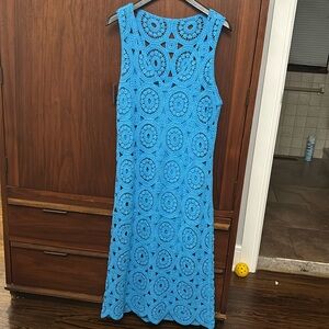 Sleeveless sweater dress with slip underneath.